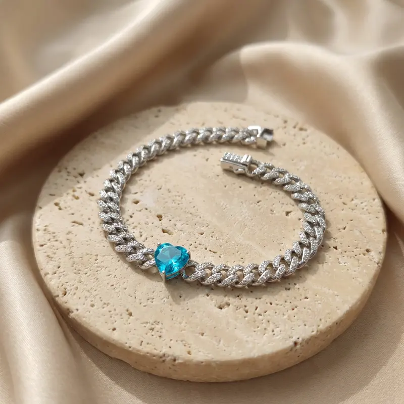 Aqua heart pavé curb bracelet on a travertine disc with silk