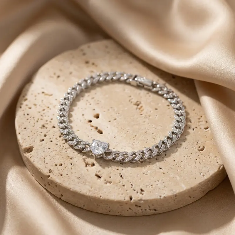 Clear heart pavé curb bracelet on a travertine disc with silk