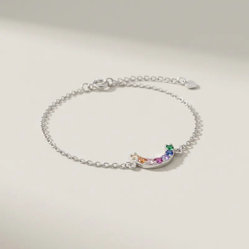 Rainbow arc bracelet on an off-white surface