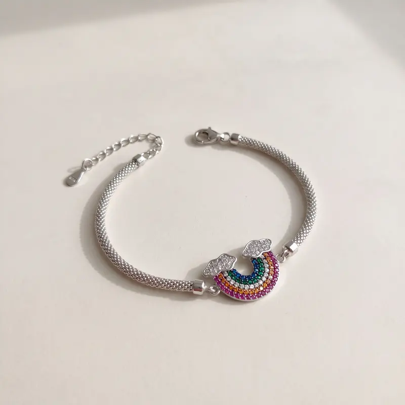 Rainbow mesh bracelet on an off-white surface