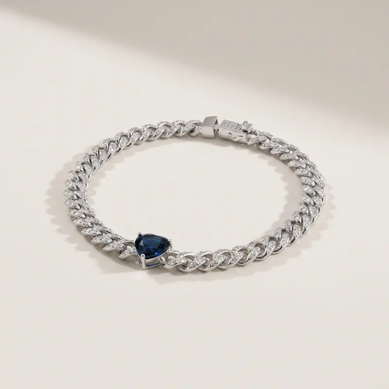 Sapphire heart pavé curb bracelet on an off-white surface