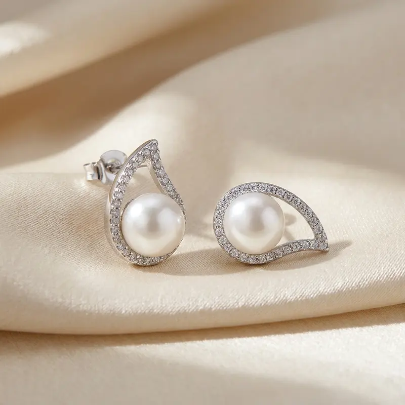 Teardrop pearl studs on champagne silk